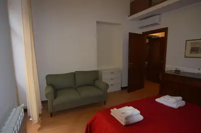 a living room with a couch and a red blanket at Carlita's Home in centro storico a Palermo in Palermo