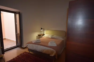 a bedroom with a bed with two towels on it at Carlita's Home in centro storico a Palermo in Palermo