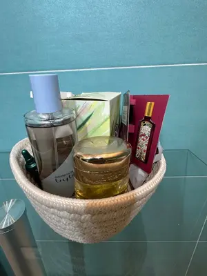 a basket filled with cosmetics on top of a glass table at Isole Siciliane Appartamento in Palermo