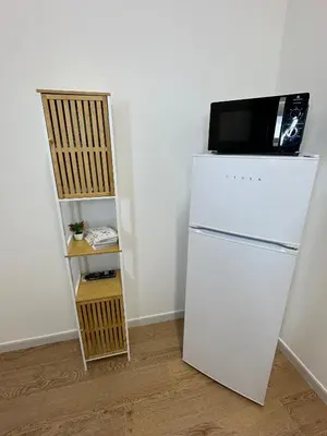 a white refrigerator with a television on top of it at Isole Siciliane Appartamento in Palermo
