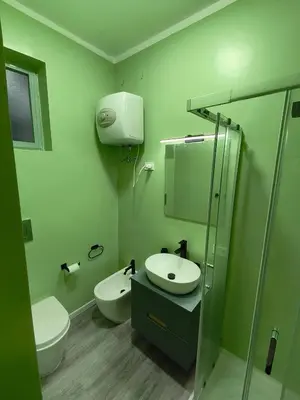 a bathroom with a sink and a toilet and a shower at Central Apartment Cavour in Palermo