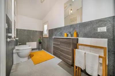 a bathroom with a toilet and a sink at Villa Coraline in Castellammare del Golfo
