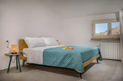 a bedroom with a bed with a plate of fruit on it at Villa Coraline in Castellammare del Golfo
