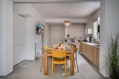 a dining room with a table and yellow chairs at Villa Coraline in Castellammare del Golfo