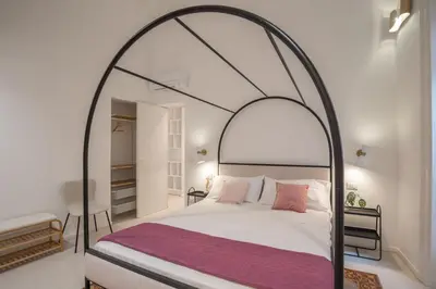 a bedroom with a canopy bed and a shower at Dimora Dodici, Heritage and Contemporary Design in Palermo