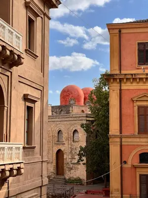 two red domes on top of a building at Dimora Dodici, Heritage and Contemporary Design in Palermo