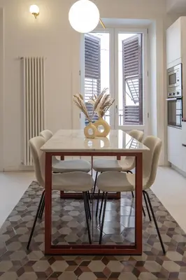 a dining room with a table and chairs at Dimora Dodici, Heritage and Contemporary Design in Palermo