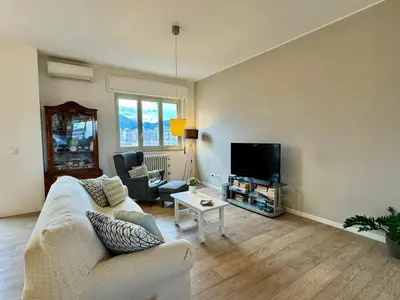 a living room with a white couch and a tv at Casa Parlatore in Palermo