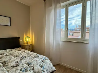 a bedroom with a bed and a window at Casa Parlatore in Palermo