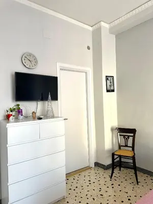 a room with a dresser and a clock on the wall at Da Nonna Marié in Palermo