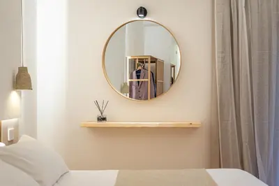 a bedroom with a mirror on a wall at Meraki Home - Alle Spalle del Teatro Massimo in Palermo