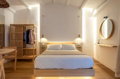 a bedroom with a bed and a mirror and a table at Meraki Home - Alle Spalle del Teatro Massimo in Palermo