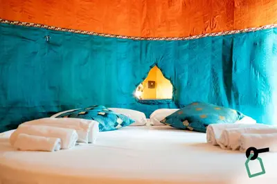 a blue room with a bed with two pillows at Hotiday Palermo Agostino in Palermo