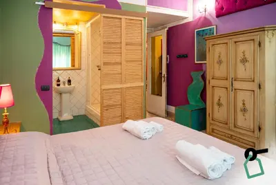 a bedroom with a bed with two towels on it at Hotiday Palermo Agostino in Palermo