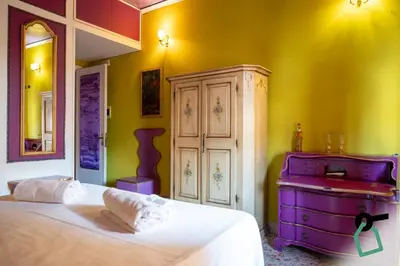 a bedroom with a large bed and a dresser at Hotiday Palermo Agostino in Palermo