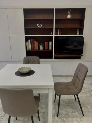 a dining room with a white table and chairs at Piazza Mameli Suite, comfort & elegance in Palermo in Palermo