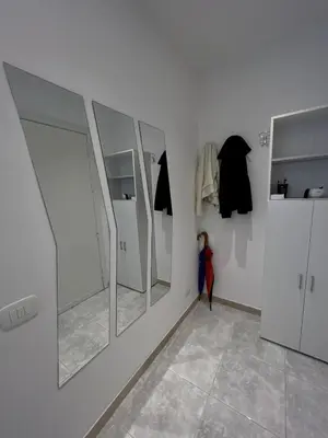 a dressing room with white walls and mirrors at Piazza Mameli Suite, comfort & elegance in Palermo in Palermo