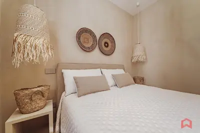 a bedroom with a bed and two hats on the wall at Strepitosa Villa Vista Mare con Piscina Privata in Terrasini