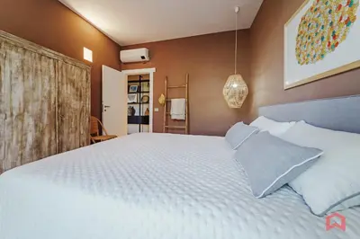 a bedroom with a bed with white sheets and pillows at Strepitosa Villa Vista Mare con Piscina Privata in Terrasini