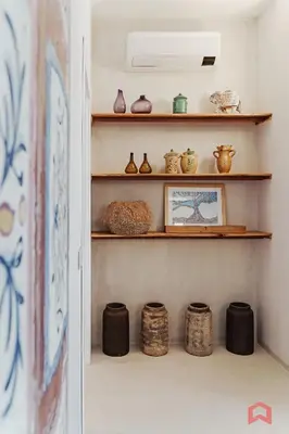a room with shelves with vases and a fan at Strepitosa Villa Vista Mare con Piscina Privata in Terrasini