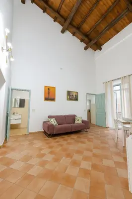 a living room with a couch and a table at Cattedrale - Vicolo Brugnò in Palermo