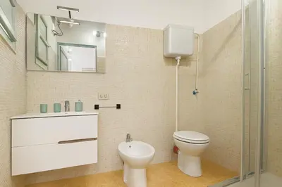 a bathroom with a toilet and a sink at Cattedrale - Vicolo Brugnò in Palermo
