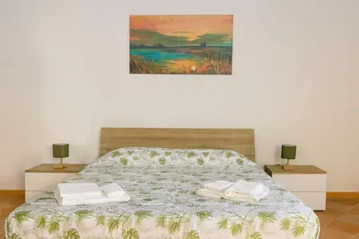 a bedroom with a bed with two towels on it at Cattedrale - Vicolo Brugnò in Palermo