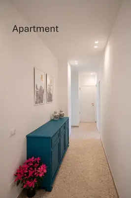 a hallway with a blue cabinet and flowers in a room at Accordi al Politeama in Palermo