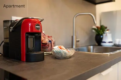 a red toaster sitting on a counter next to a sink at Accordi al Politeama in Palermo