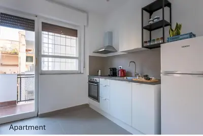 a kitchen with white cabinets and a refrigerator at Accordi al Politeama in Palermo