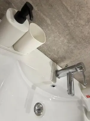 a bathroom sink with a roll of toilet paper on it at Ughetti Apartment in Palermo