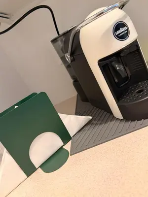 a toaster sitting on top of a counter with a piece of paper at Ughetti Apartment in Palermo