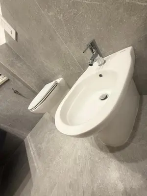 a bathroom with a white toilet and a sink at Ughetti Apartment in Palermo