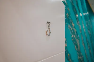 a hook on a wall with a blue curtain at Cama Luxury Rooms in Palermo