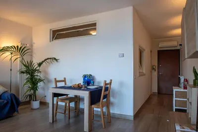 a dining room with a table and chairs at CasaMare Addaura - Your Romantic Seafront Hideaway in Palermo