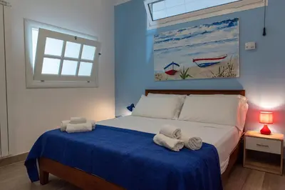 a bedroom with a bed with towels on it at CasaMare Addaura - Your Romantic Seafront Hideaway in Palermo