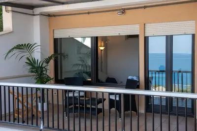 a balcony with a view of the ocean at CasaMare Addaura - Your Romantic Seafront Hideaway in Palermo