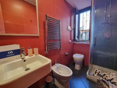 a bathroom with a white sink and a toilet at Pruni's Home by Holiday World in Palermo