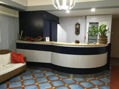 a man sitting at a bar in a room at Hotel Villa Mare in Altavilla Milicia