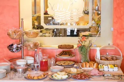 a table with many different types of food on it at Hotel Villa Mare in Altavilla Milicia