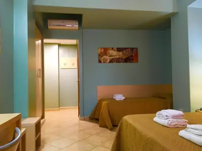 a hotel room with two beds and a hallway at Hotel Villa Mare in Altavilla Milicia