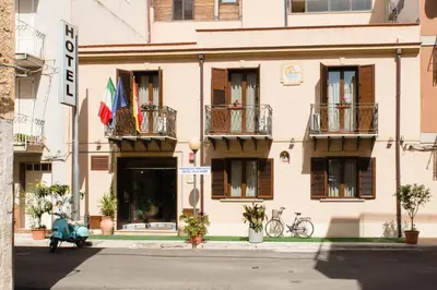 a building with balconies and a scooter parked in front of it at Hotel Villa Mare in Altavilla Milicia