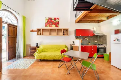 a living room with a yellow couch and a table at La petite Bastet in Palermo