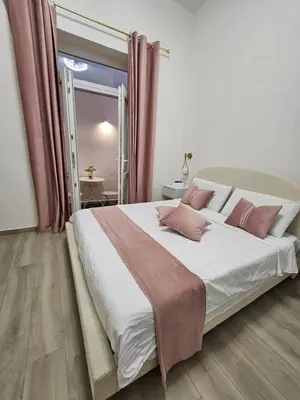 a bedroom with a large bed and a television at TraMondi in Palermo