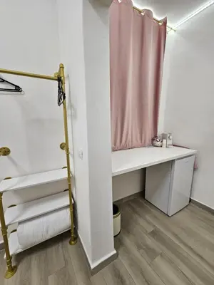 a white bedroom with a bed and two lights at TraMondi in Palermo