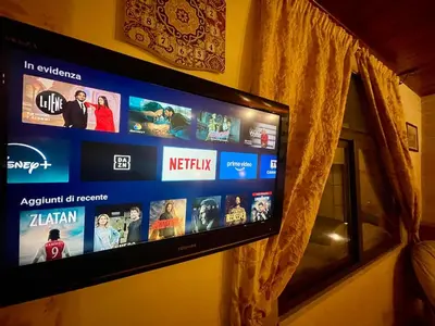 a flat screen tv hanging on a wall at Tenute Armani The Castle Live an Experience in Altavilla Milicia