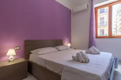 a bedroom with a bed with two towels on it at 15 min to Historic Center, 5 min to Bus, Balcony in Palermo