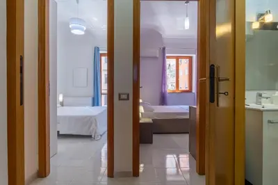 a room with two beds and a room with a bathroom at 15 min to Historic Center, 5 min to Bus, Balcony in Palermo
