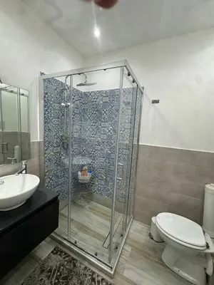a bathroom with a shower and a toilet and a sink at Anastasia House in Palermo