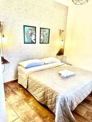 a bedroom with a bed with two towels on it at Via del Bosco Home in Palermo